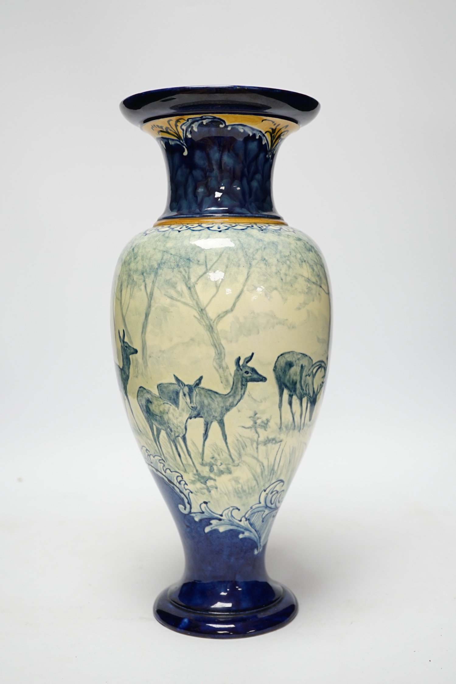 A Doulton Lambeth faience vase, c.1900, attributed to Hannah Barlow, painted with deer in woodland, monogram to the body, and to the base ‘KBS’ for Katherine B. Smallfield, 35cm, high, cf. Bonhams, Knightsbridge, London,